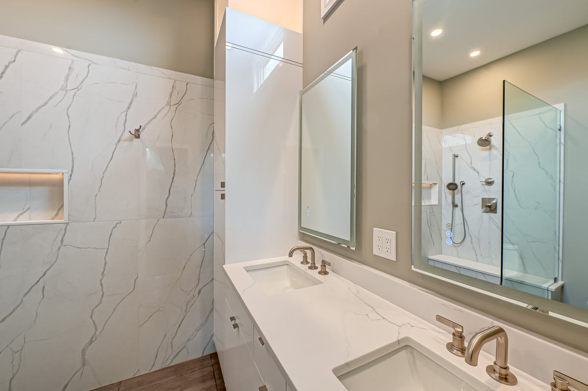 Double sink vanity with quartz countertop and LED mirrors in Suffolk County custom bathroom