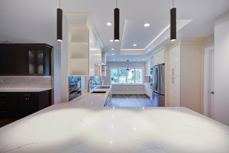 Custom kitchen with tray ceiling and wide quartz countertops in Suffolk County by Long Island Creative Contracting, Inc